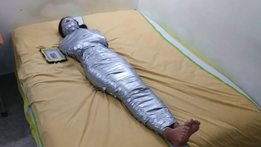 エジプトのミイラのようにダクトテープを巻かれた若い女の子