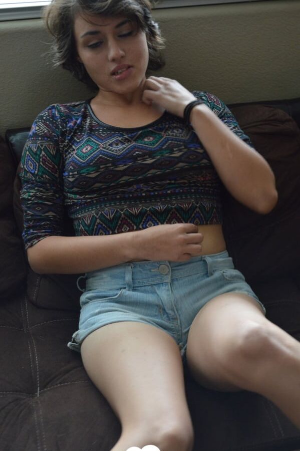 Pretty brunette satisfies herself on the couch