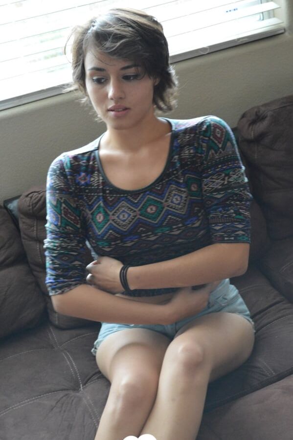 Pretty brunette satisfies herself on the couch
