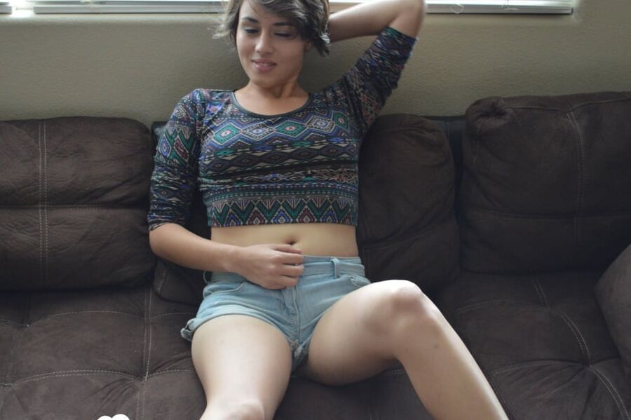 Pretty brunette satisfies herself on the couch