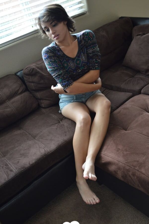 Pretty brunette satisfies herself on the couch