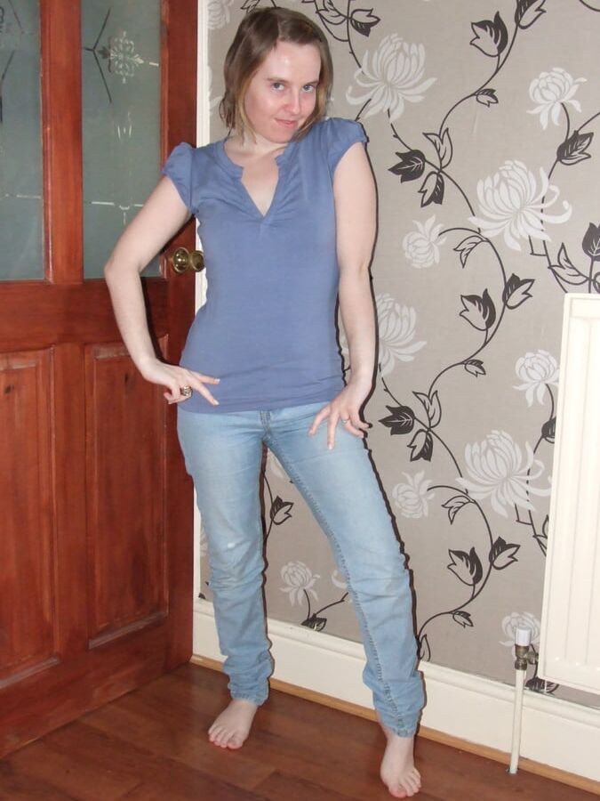 Cute blonde posing in jeans and shirt