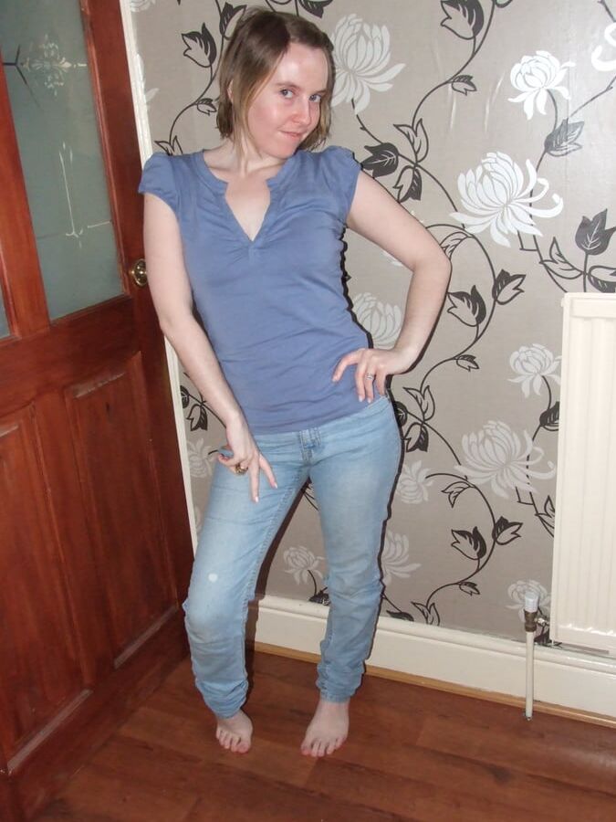 Cute blonde posing in jeans and shirt