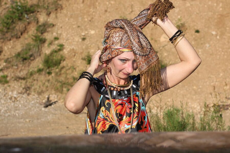 With Pear in Colorful Dress on Sand