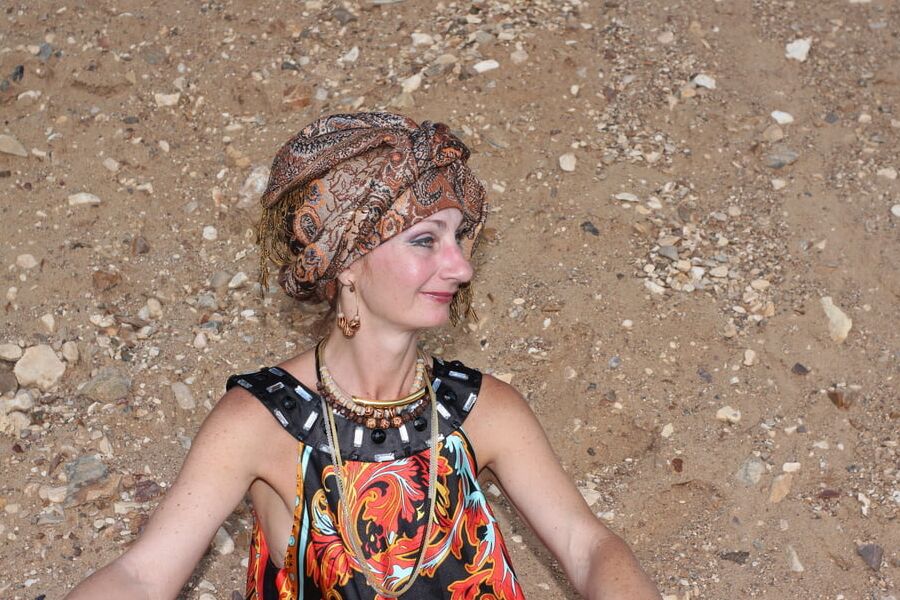 With Pear in Colorful Dress on Sand