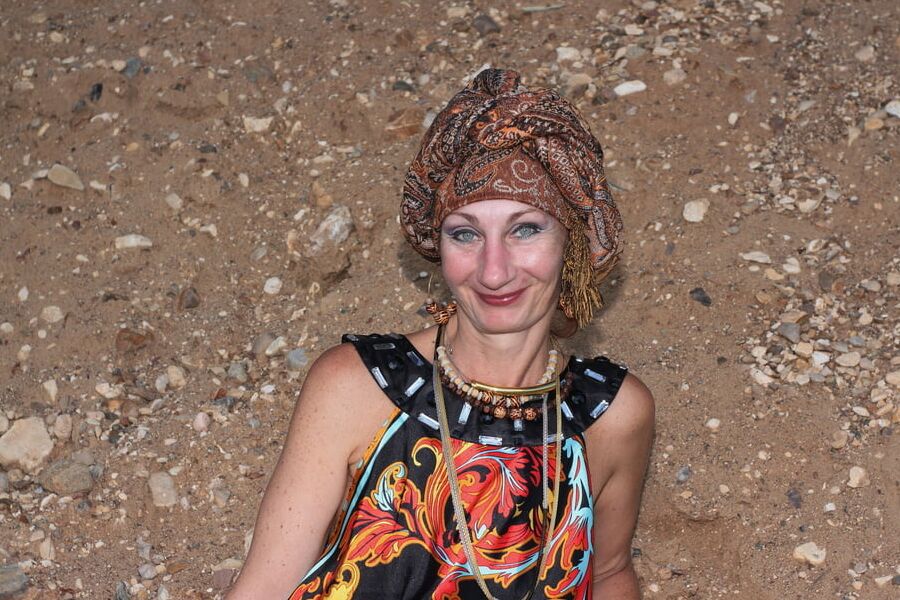 With Pear in Colorful Dress on Sand