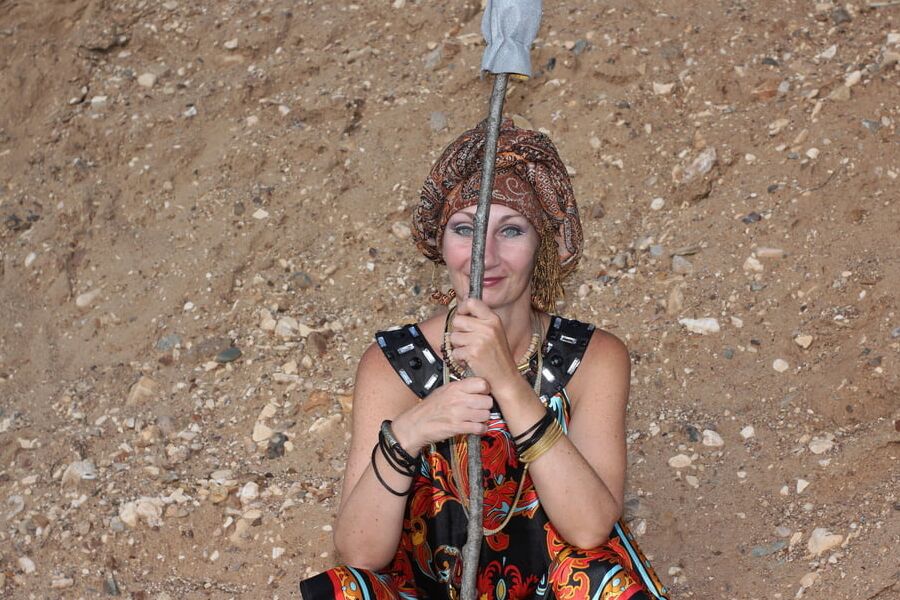 With Pear in Colorful Dress on Sand