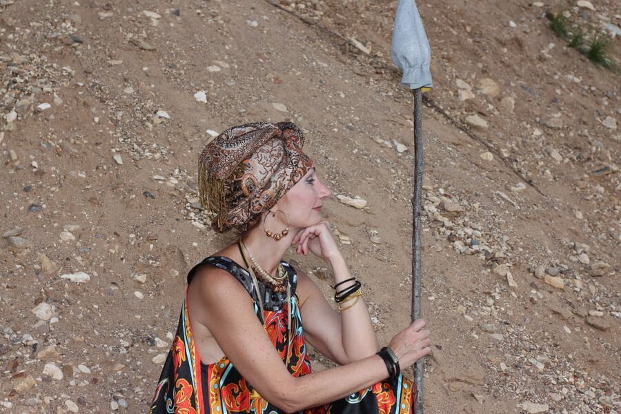 With Pear in Colorful Dress on Sand