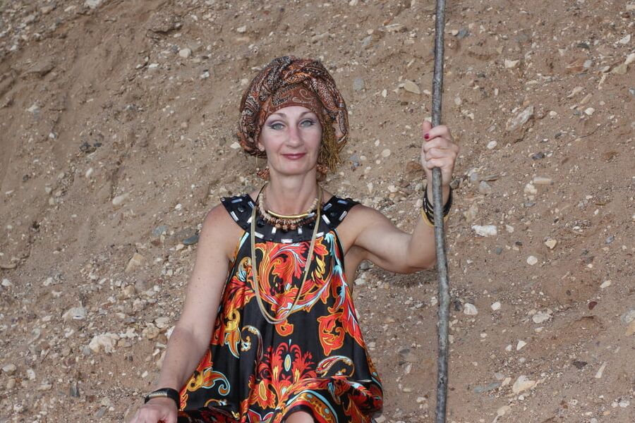 With Pear in Colorful Dress on Sand