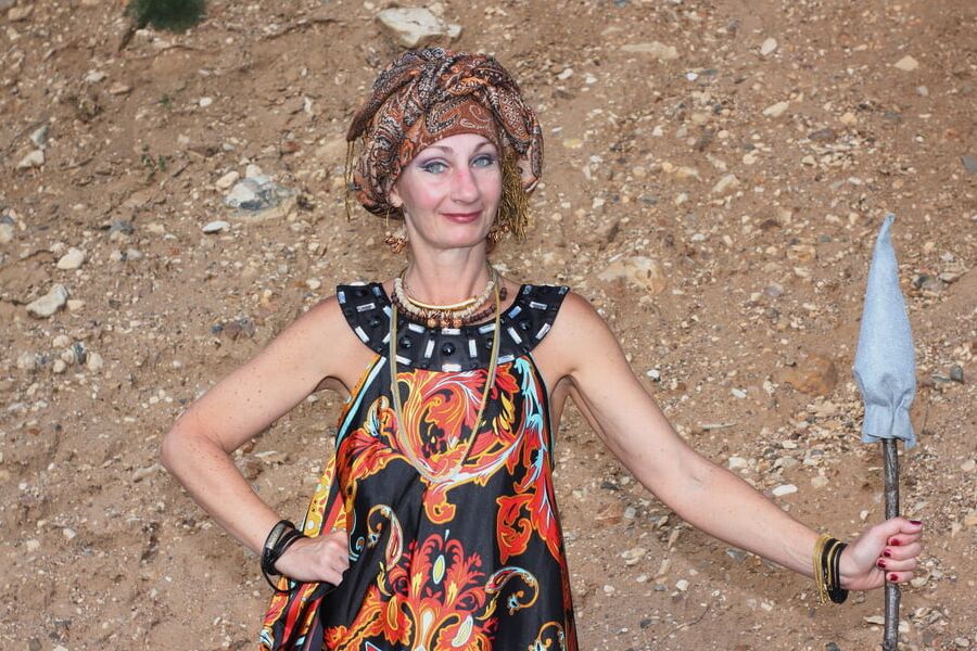 With Pear in Colorful Dress on Sand