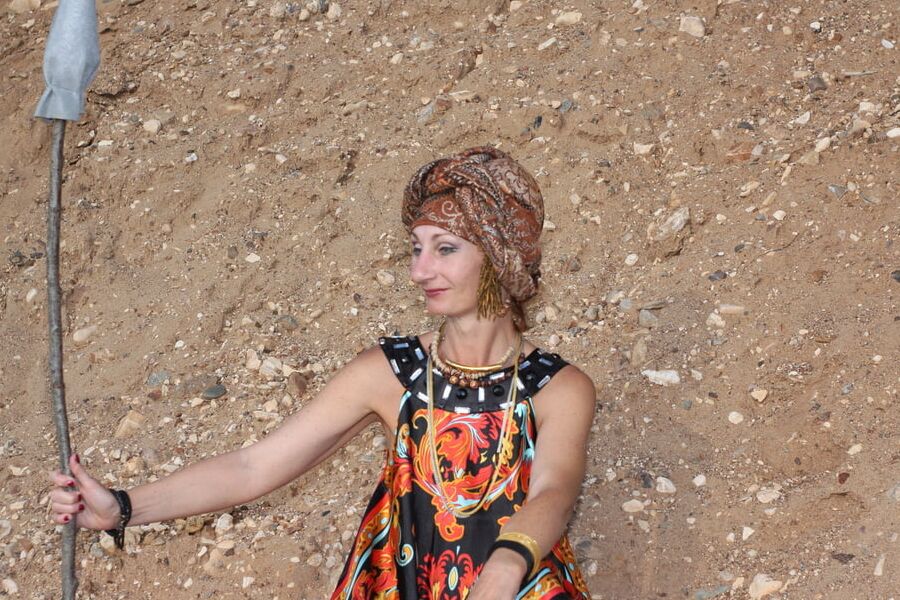 With Pear in Colorful Dress on Sand