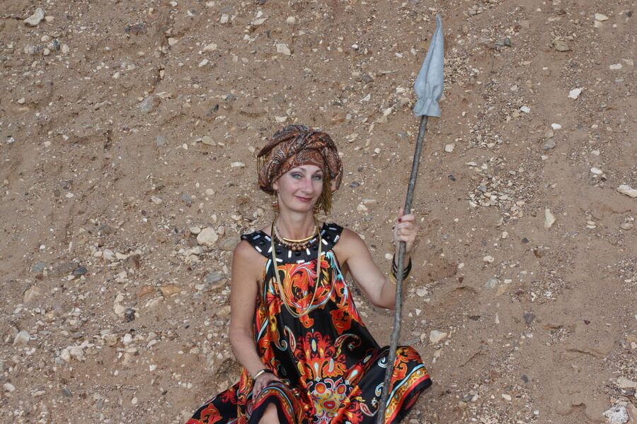 With Pear in Colorful Dress on Sand