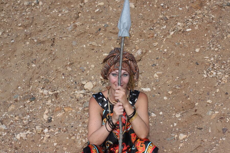 With Pear in Colorful Dress on Sand