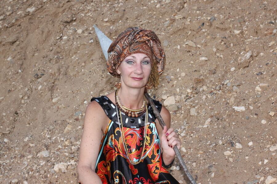 With Pear in Colorful Dress on Sand