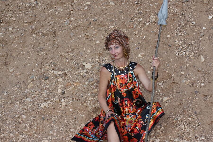 With Pear in Colorful Dress on Sand
