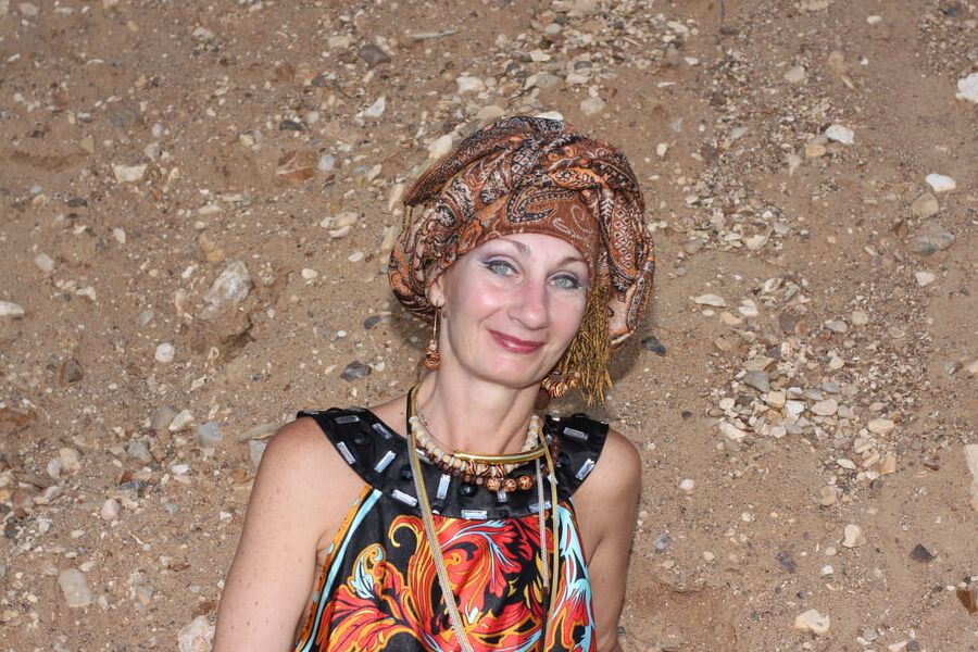 With Pear in Colorful Dress on Sand