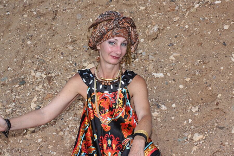 With Pear in Colorful Dress on Sand