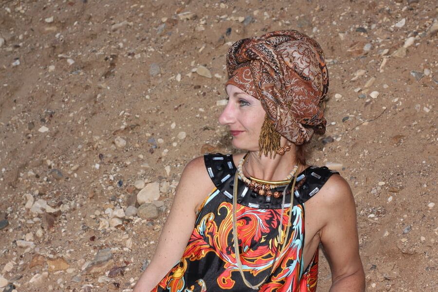 With Pear in Colorful Dress on Sand