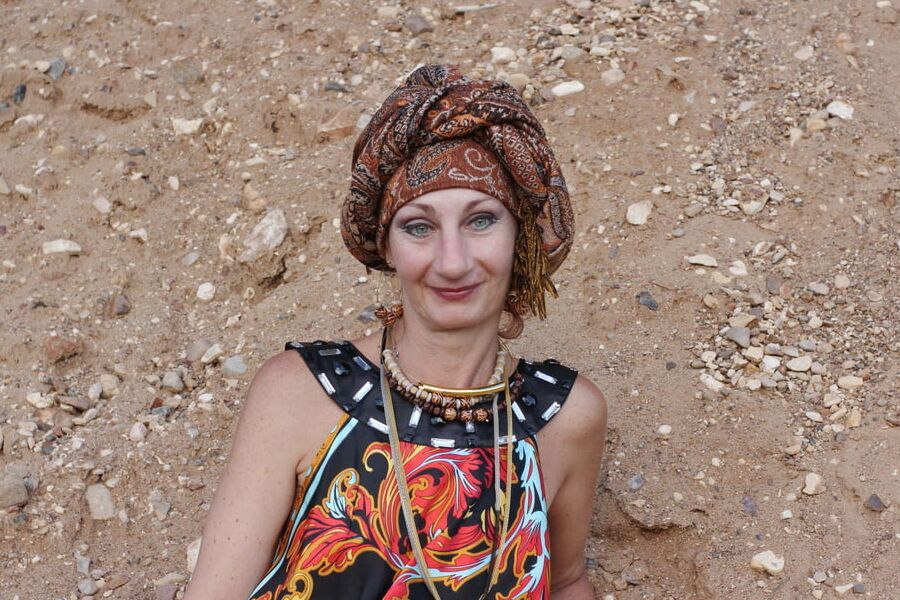 With Pear in Colorful Dress on Sand