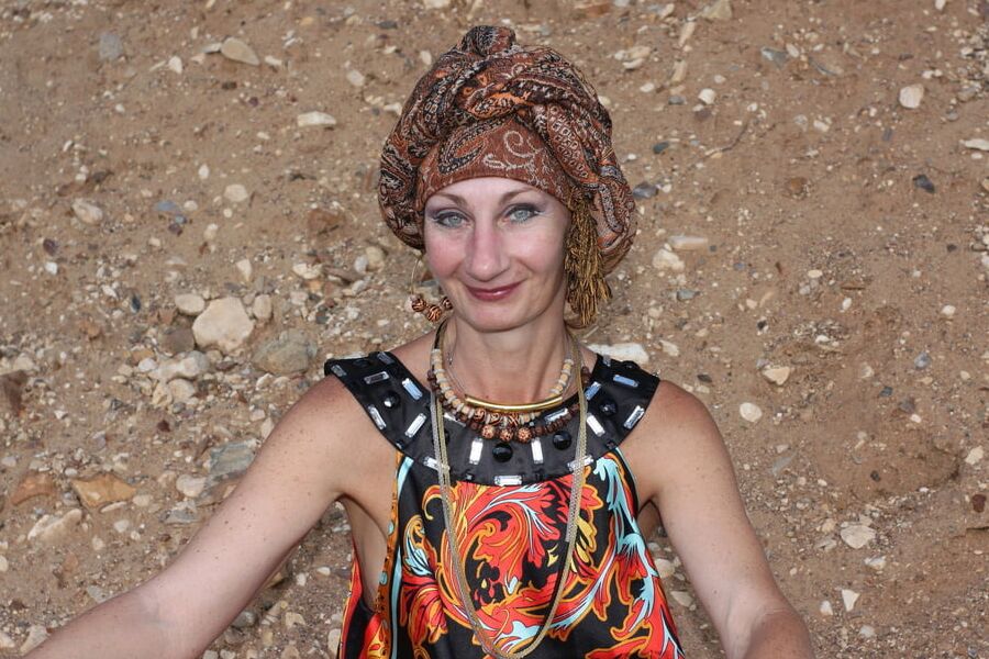 With Pear in Colorful Dress on Sand