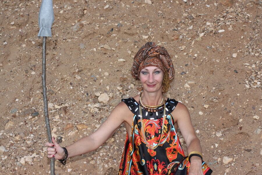 With Pear in Colorful Dress on Sand