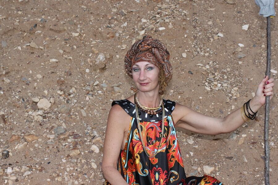 With Pear in Colorful Dress on Sand