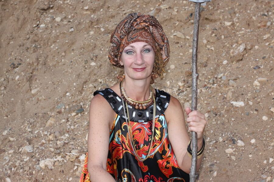 With Pear in Colorful Dress on Sand