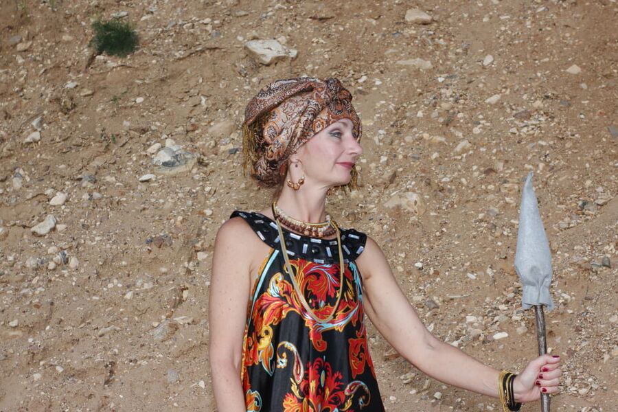 With Pear in Colorful Dress on Sand