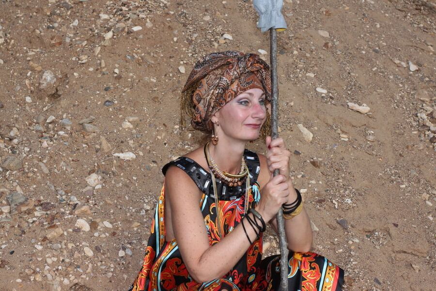 With Pear in Colorful Dress on Sand