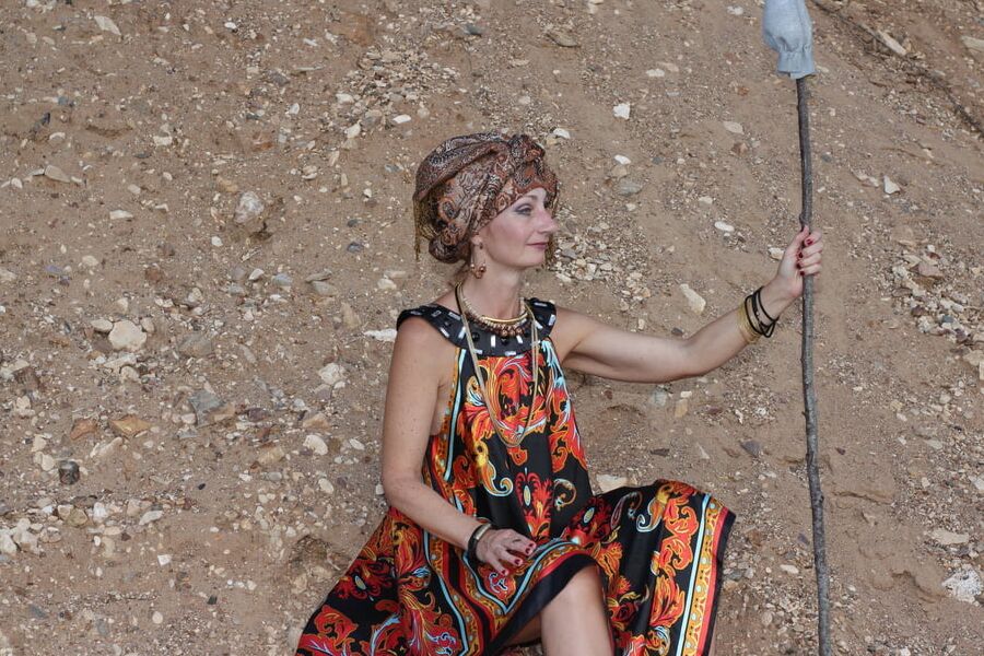 With Pear in Colorful Dress on Sand