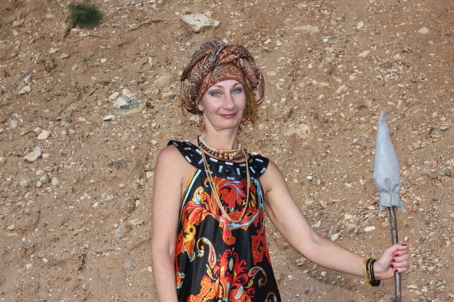 With Pear in Colorful Dress on Sand