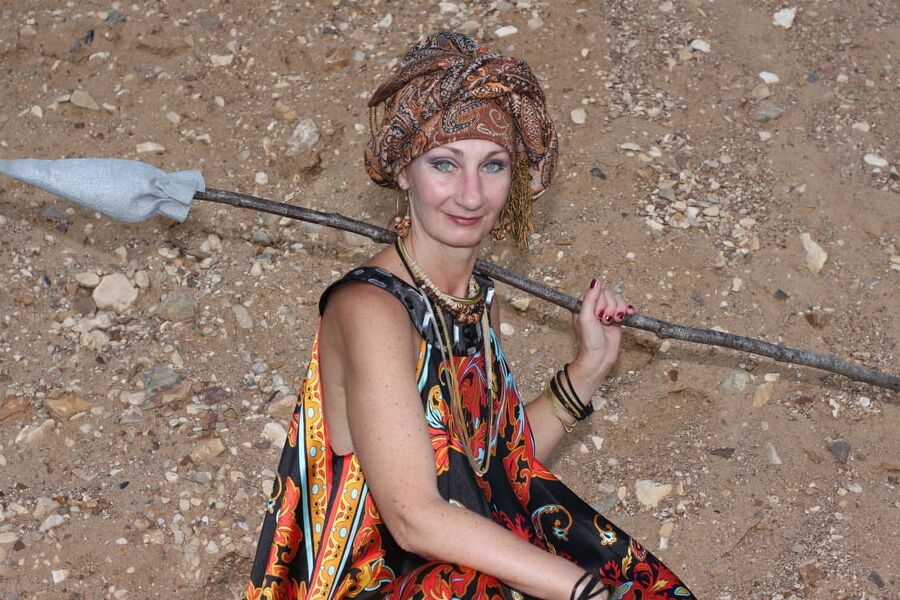 With Pear in Colorful Dress on Sand