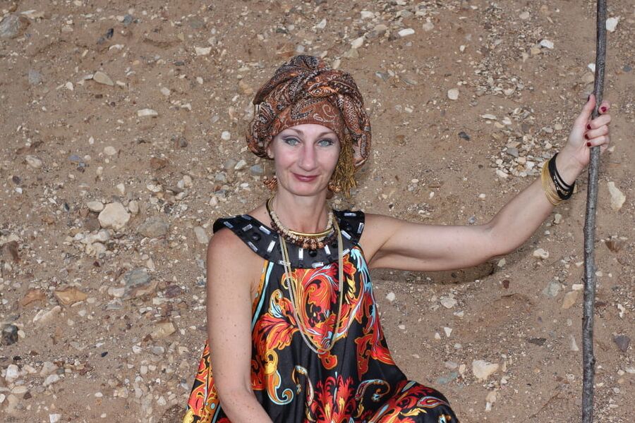 With Pear in Colorful Dress on Sand