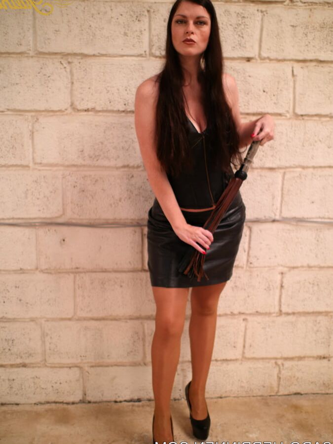Mistress Lady Julina wears leather skirt and pantyhose
