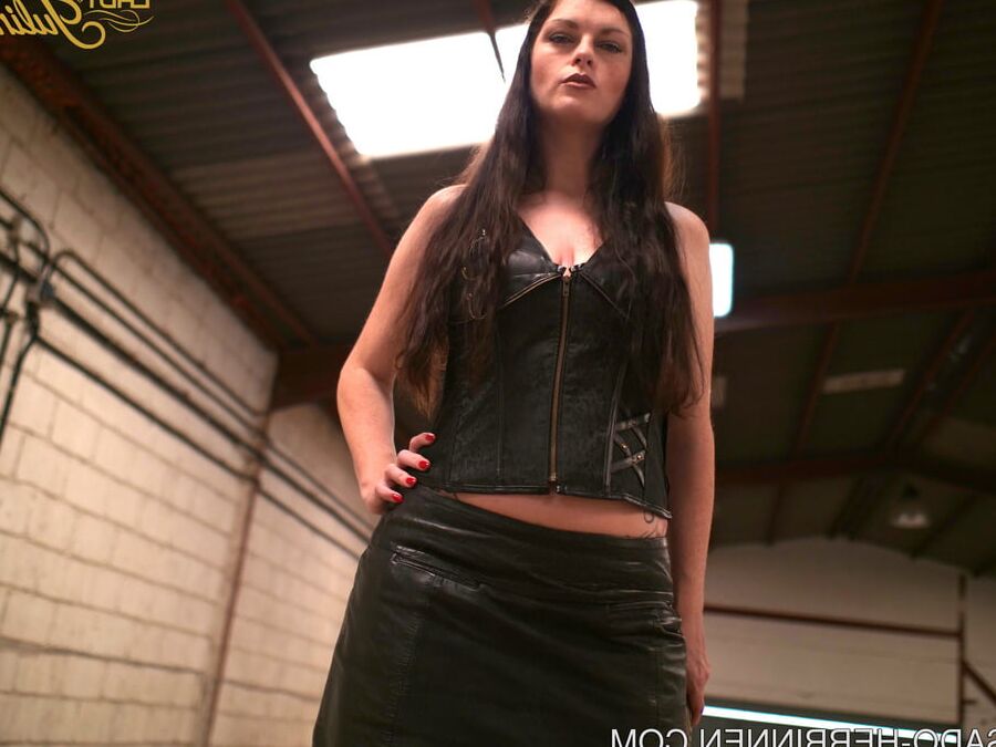 Mistress Lady Julina wears leather skirt and pantyhose