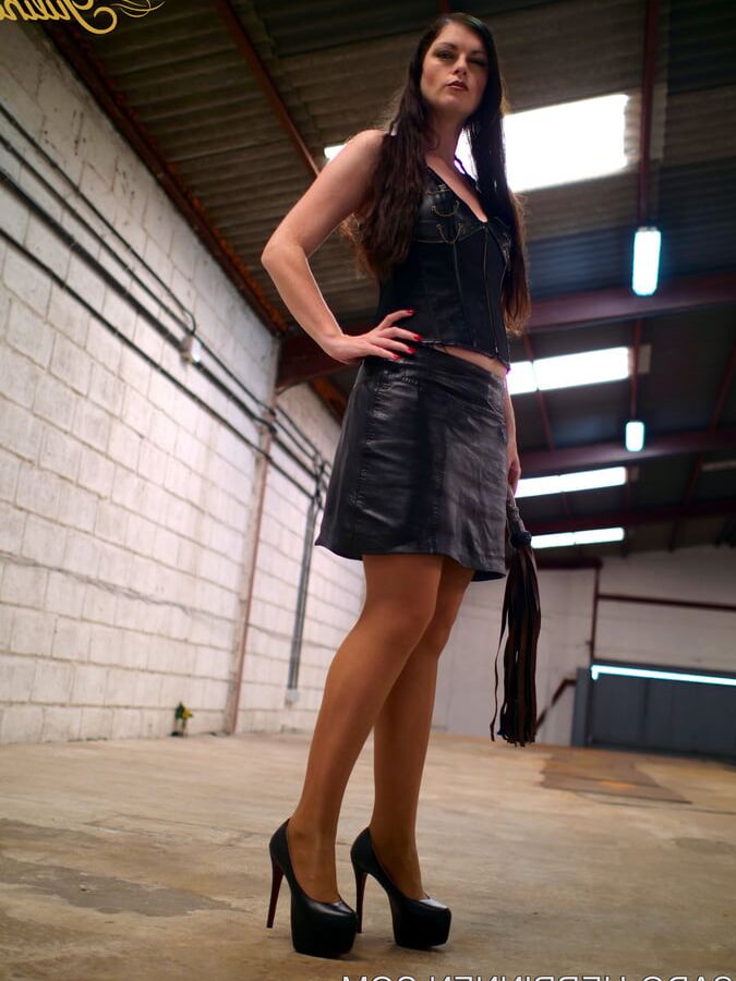 Mistress Lady Julina wears leather skirt and pantyhose