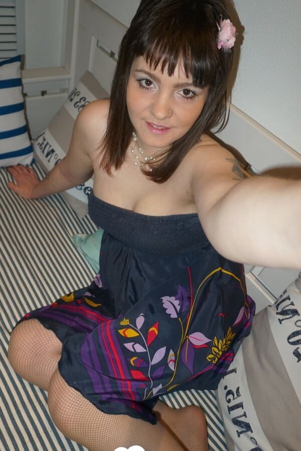 Brunette teen teasing in stockings in the bedroom