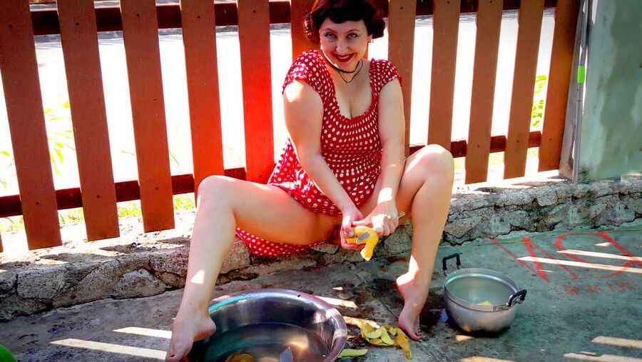 Retro maid prepares potatoes for dinner. Vintage performance