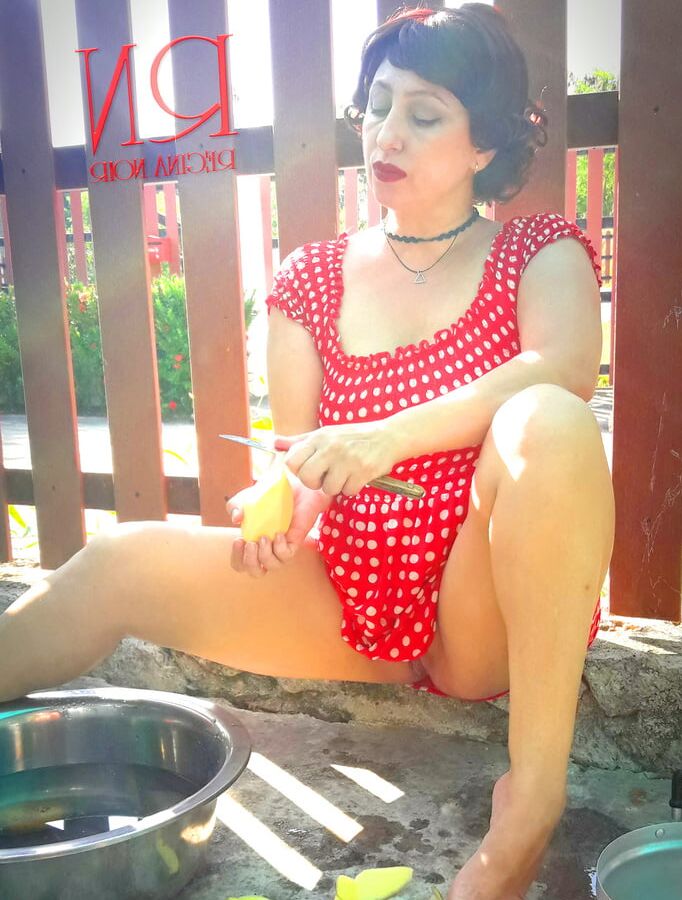 Retro maid prepares potatoes for dinner. Vintage performance