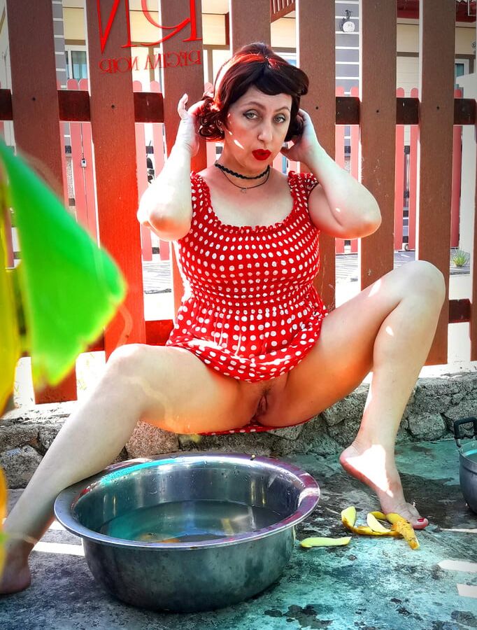 Retro maid prepares potatoes for dinner. Vintage performance
