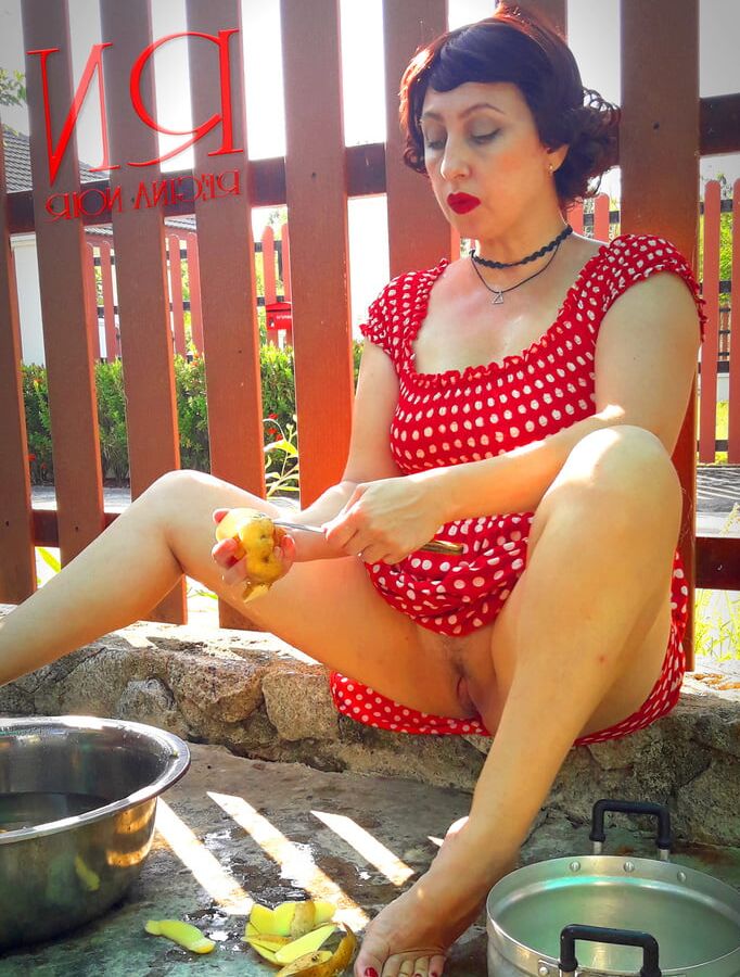 Retro maid prepares potatoes for dinner. Vintage performance