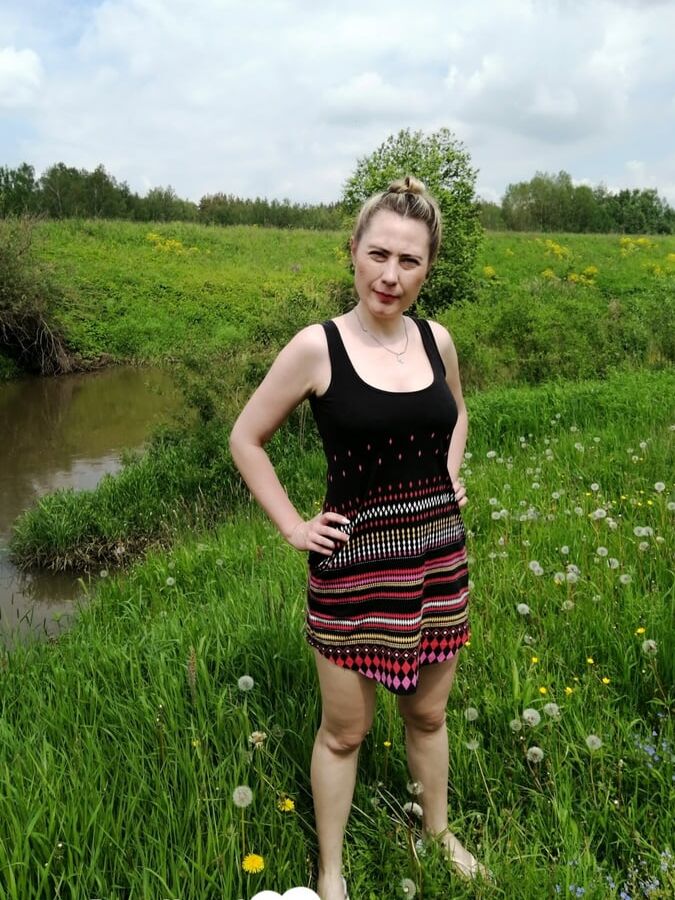 Sensational beauty being naked in the grass