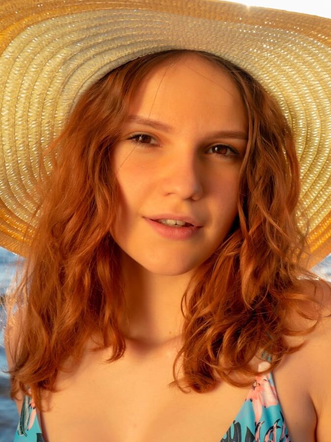 Beach relaxation with a young redhead girl Verlonis