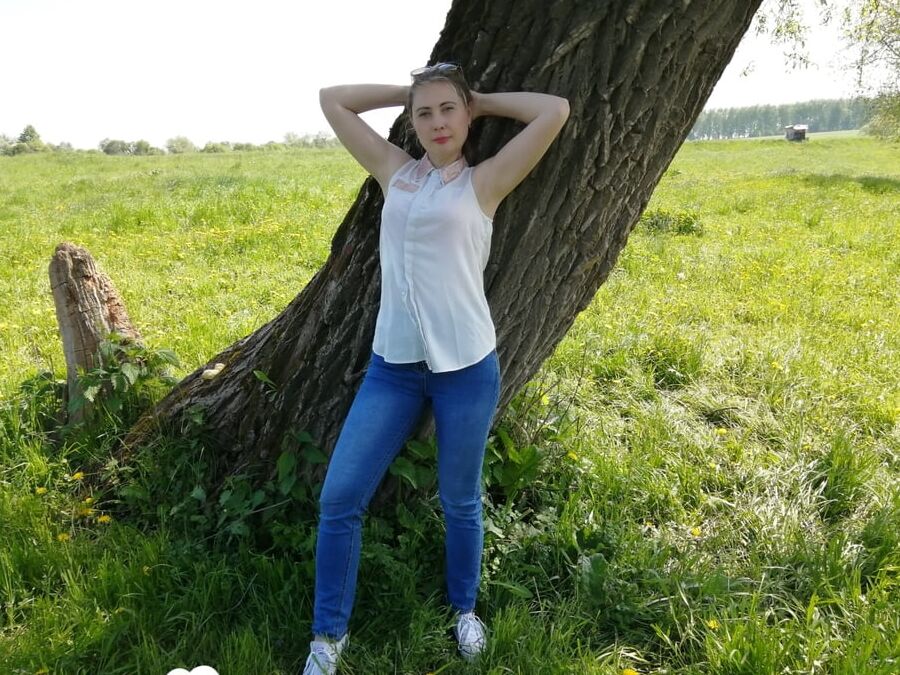 Sexy mom shows off by the tree