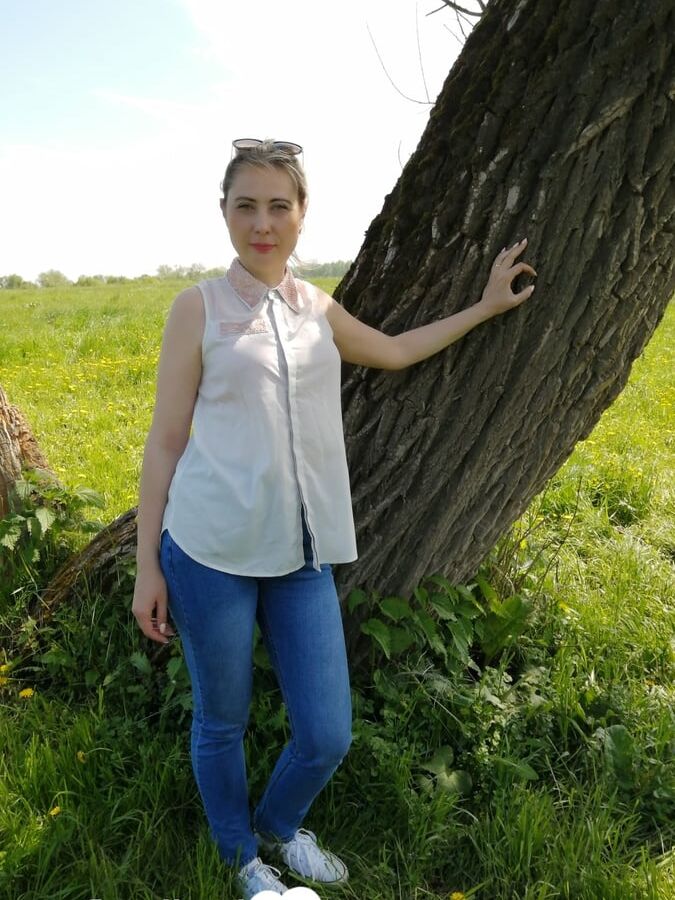 Sexy mom shows off by the tree