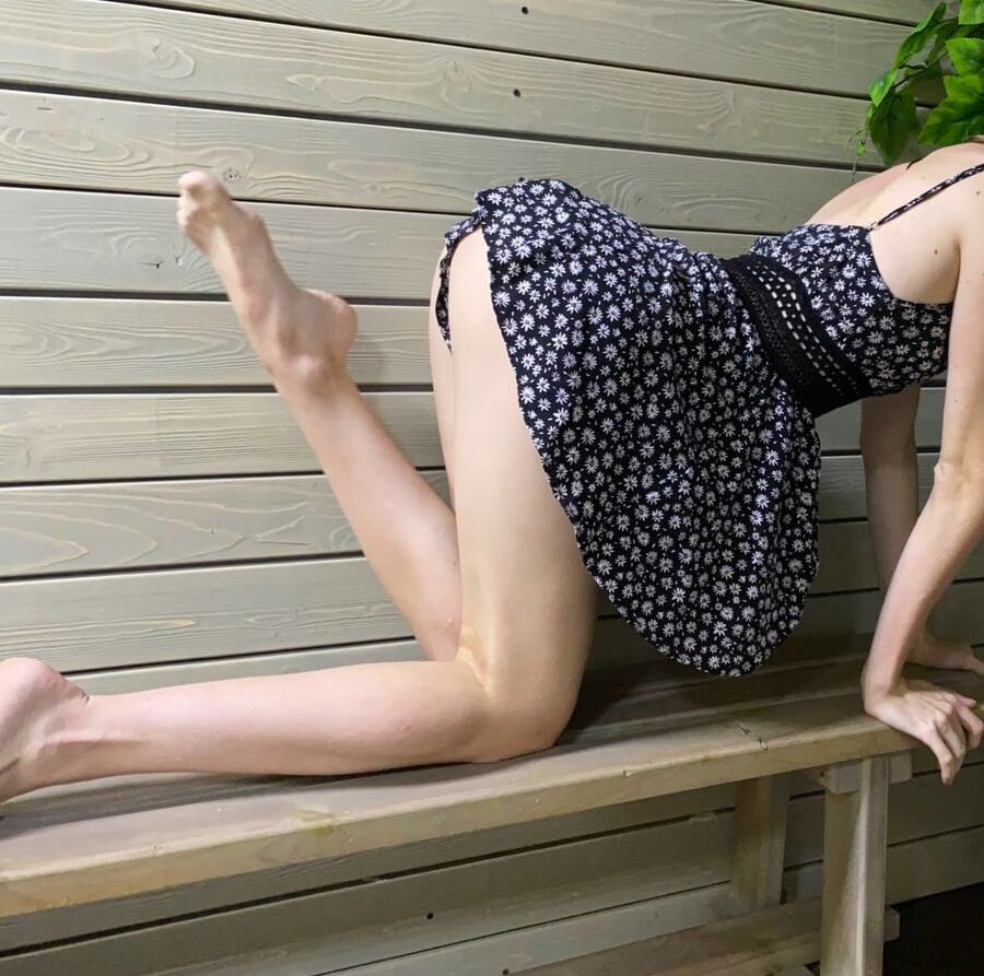 A small dress on a tall girl in a public place