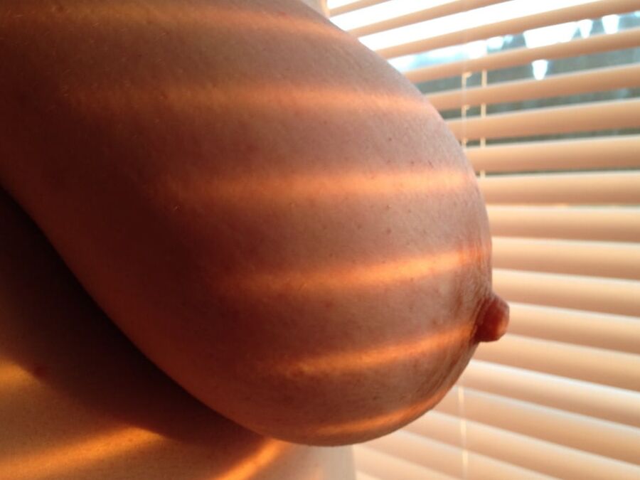 Young BBW by window evening sunset