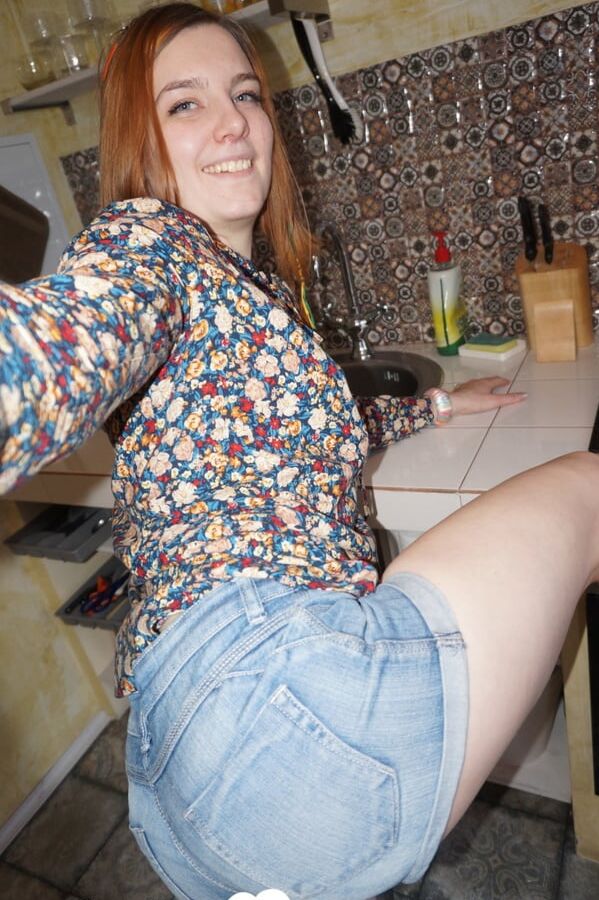 Cute redhead in socks shows off her body