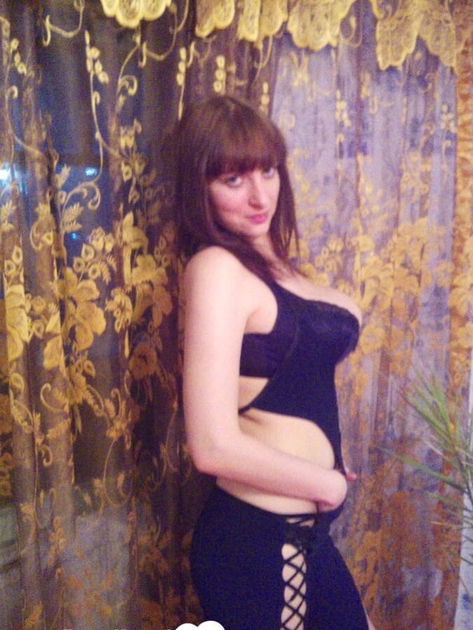 MILF in a seductive purple dress fooling around