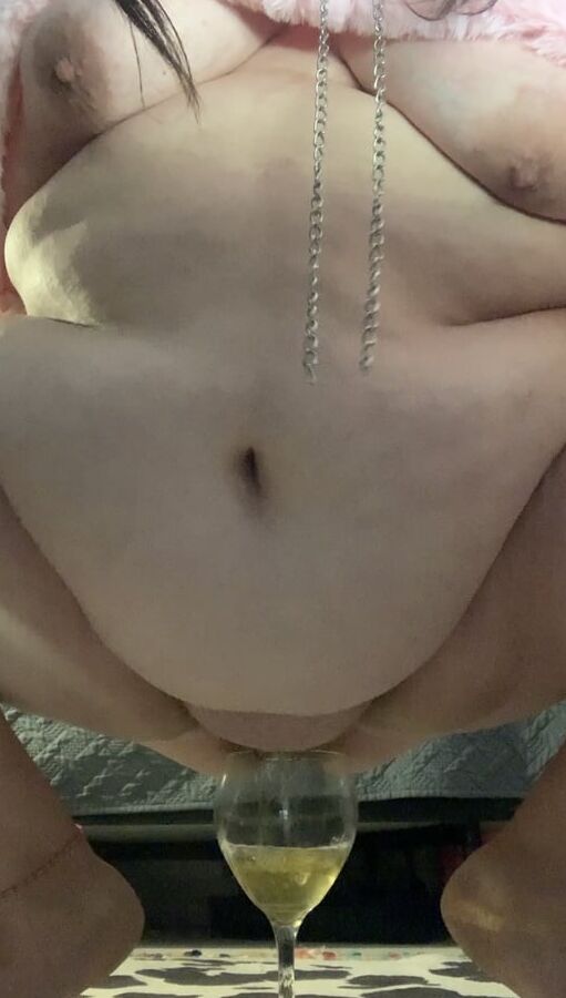 Fat piggy squats over wine glass